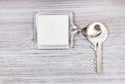 key with key chain on wooden board